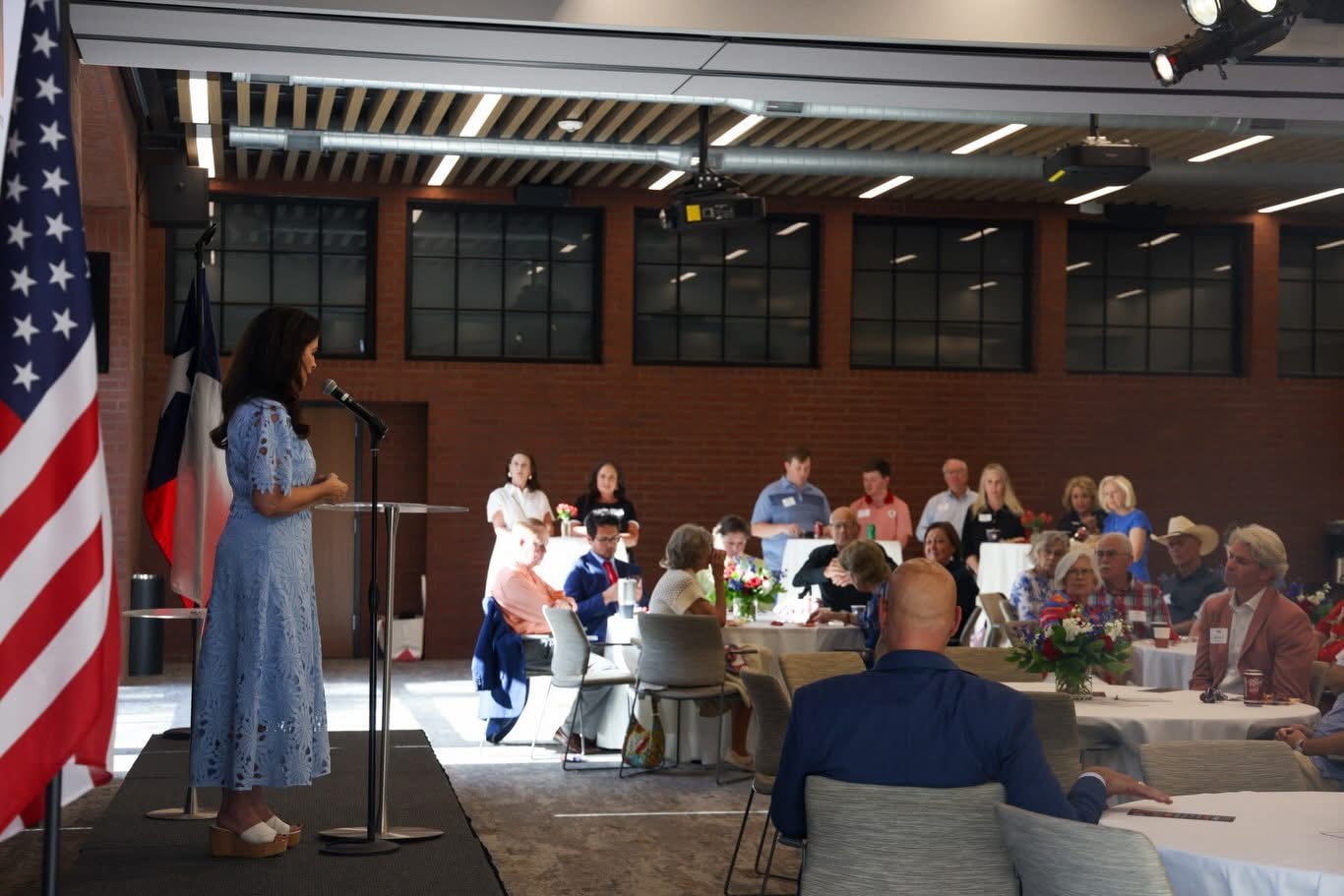 Ashley speaking at a luncheon event